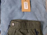 men ' s clothing including a sweater, pants, and a cell phone