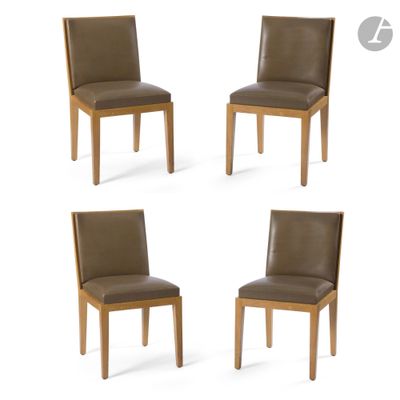 four brown leather dining chairs with wooden legs and backrests