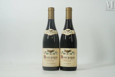 deux bouteilles de vin posées sur une table blanche