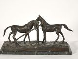 bronze sculpture of two horses pulling a plow on a marble base
