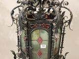 an old fashioned lantern hanging from the ceiling of a room