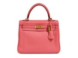 a pink leather handbag on a white background