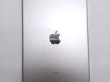 an apple ipad sitting on top of a white table next to a white wall