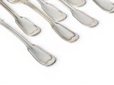 six silver spoons and six silver spoons on a white surface