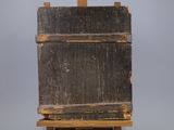 an old wooden easel with a piece of wood on top of it