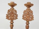 pair of wooden candlesticks with ornate designs on them