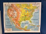 a map hanging on the wall of a public restroom