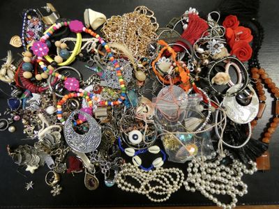a black table with a bunch of jewelry on it