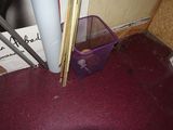 a purple container sitting on the floor next to a door