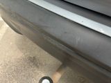 a close up of a car ' s bumper with a small tire