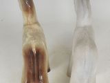 two ceramic figurines of a dog and a cat on a white background