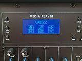a close up of a digital mixer with a clock on it