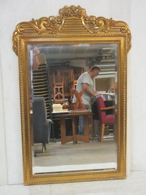 a man standing in front of a mirror in a room