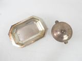 two silver objects on a white surface