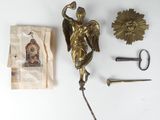 a gold statue of an angel next to a pair of scissors and a piece of paper