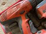 an image of two electric tools in a case on the floor