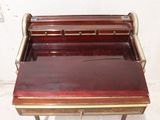 a small desk with a wooden top and a drawer on it