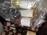 bottles of wine are wrapped in plastic bags on a bed