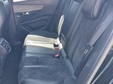 the back seats of a car with a black leather seat cover