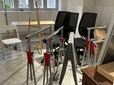 a room with a desk, chairs, and a mirror in it