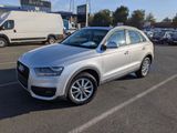 the audi q3 is parked in a parking lot with other cars in the background