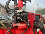 une image représentant un camion rouge avec une machine à l'arrière