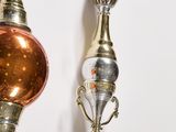 two ornaments hanging on the wall next to each other