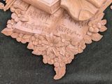 a wooden sculpture of a guitar and a book on a table