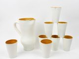 a lot of cups and a pitcher on the table
