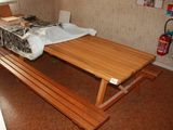 a wooden bench in the corner of a room