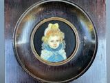 a picture of a little girl in a blue dress in a picture frame