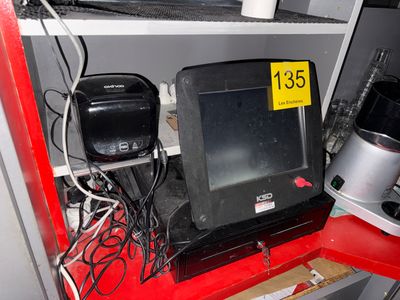 a computer monitor sitting on top of a red shelf