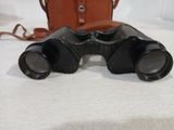 an old pair of binoculars sitting on top of a white table