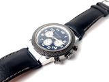 a watch that is sitting on top of a black leather strap