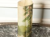 a vase that has a picture of a forest on it