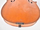 a violin that is sitting on a white surface
