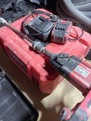 a red tool box with two tools on top of it