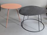 two tables with different colored tops sit side by side on a white surface
