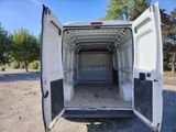a white van with its doors open in the dirt