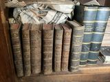 many old books sitting on a shelf in a room