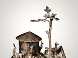an image of a silver figurine of a manger with animals and a tree