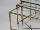 pair of brass and glass coffee tables with glass tops