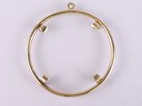 a gold plated metal circle with four small squares inside