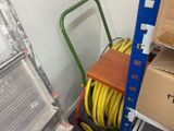 une échelle et un chariot dans une pièce où se trouvent de nombreuses caisses
