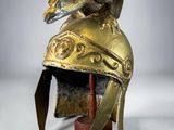 an image of a golden helmet with an elephant ' s head on it