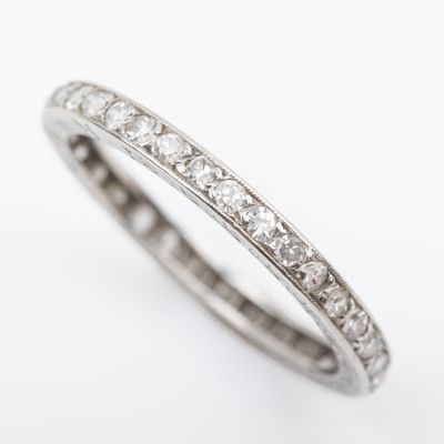 a close up view of a white gold diamond eternity ring