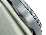 a close up of a watch on a white surface