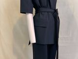 the mannequin is wearing a black suit with a belt