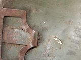 a rusted piece of metal on the floor next to a wren