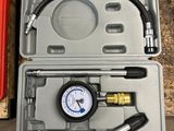 a man standing next to a tool box with a pressure gauge in it